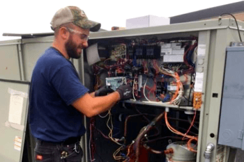 HVAC technician working on HVAC maintenance services